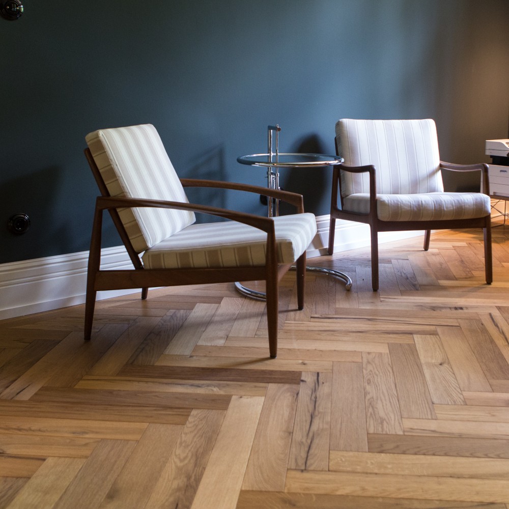 Fischgrät-Parkett aus Altholz Eiche, farbig geölt Altholzparkett, als Fischgrät verlegt, mit Möbeln